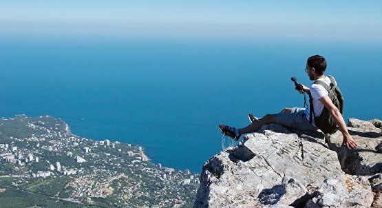 A tourist takes a photo on Ai-Petri Mountain in Crimea