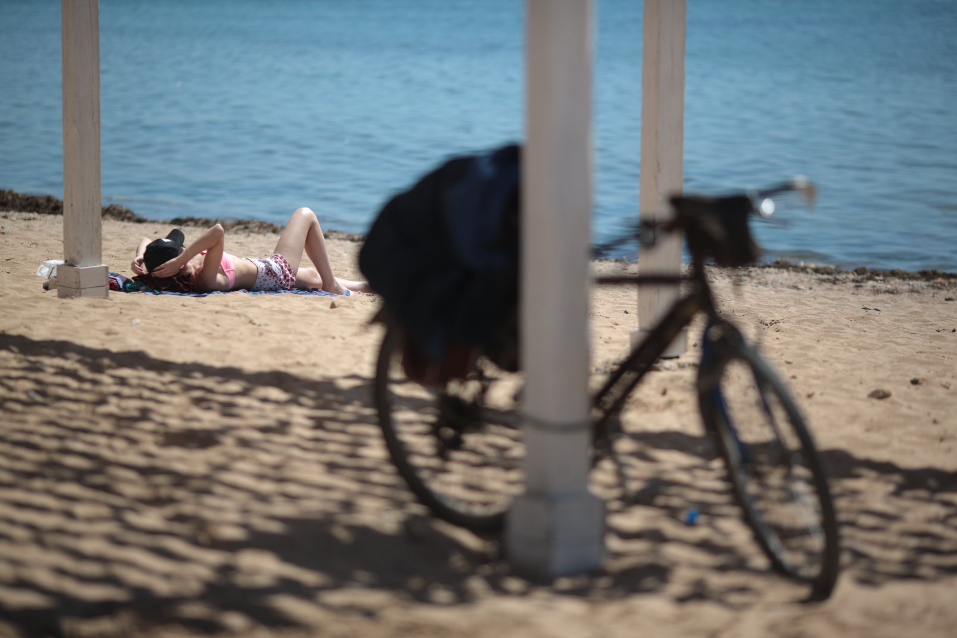 A vacationer enjoys herself on a beach in Yevpatoriya