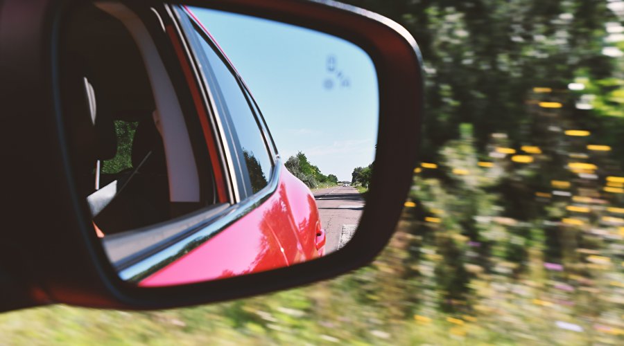 Road in the car mirror