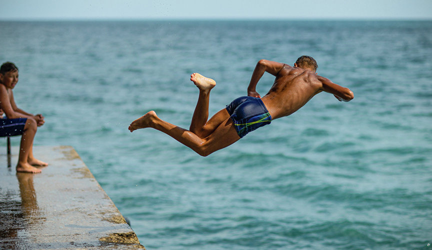 Man jumping off the pier