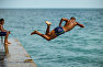 Man jumping off the pier